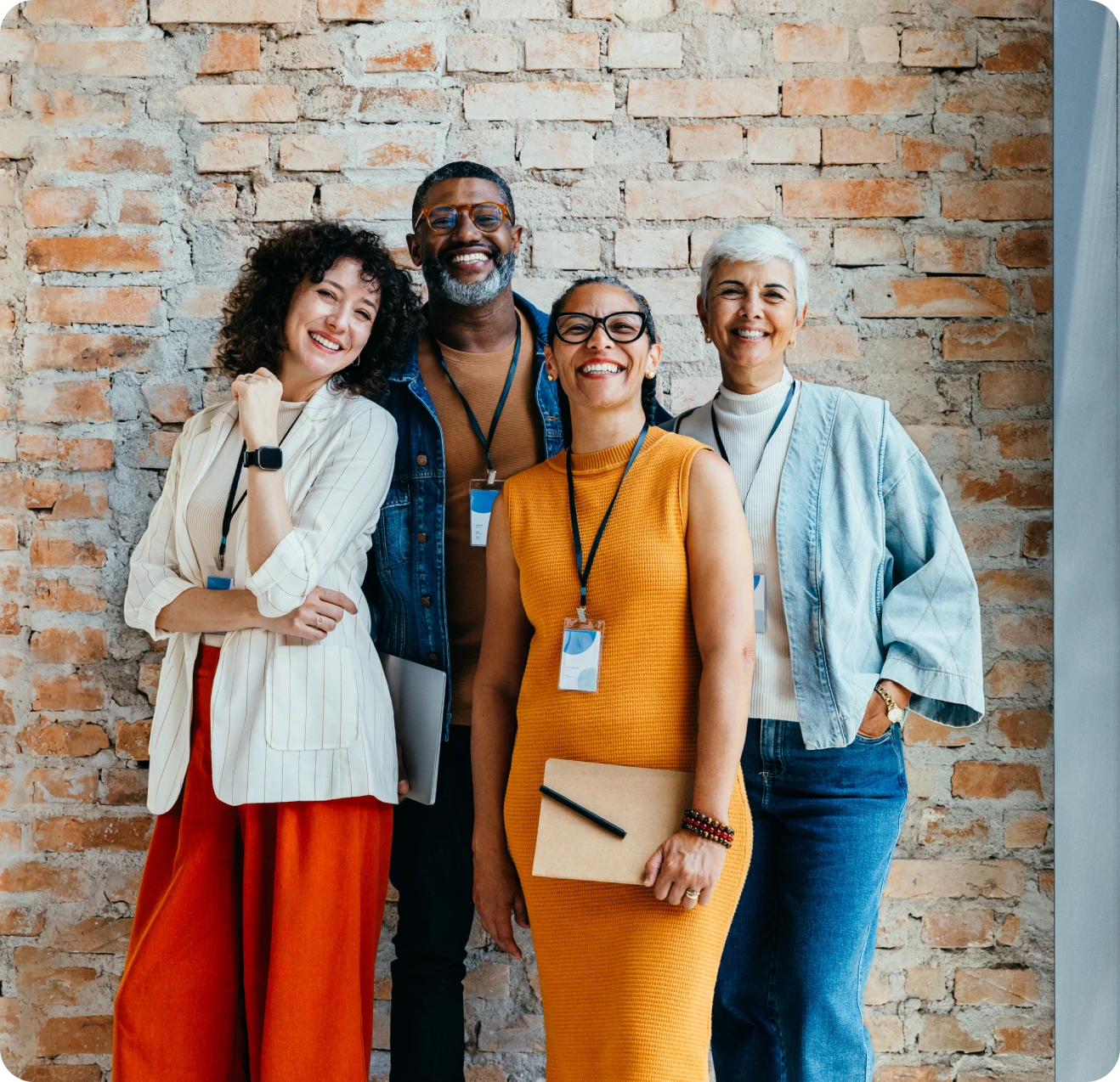 Happy colleagues standing together indoors